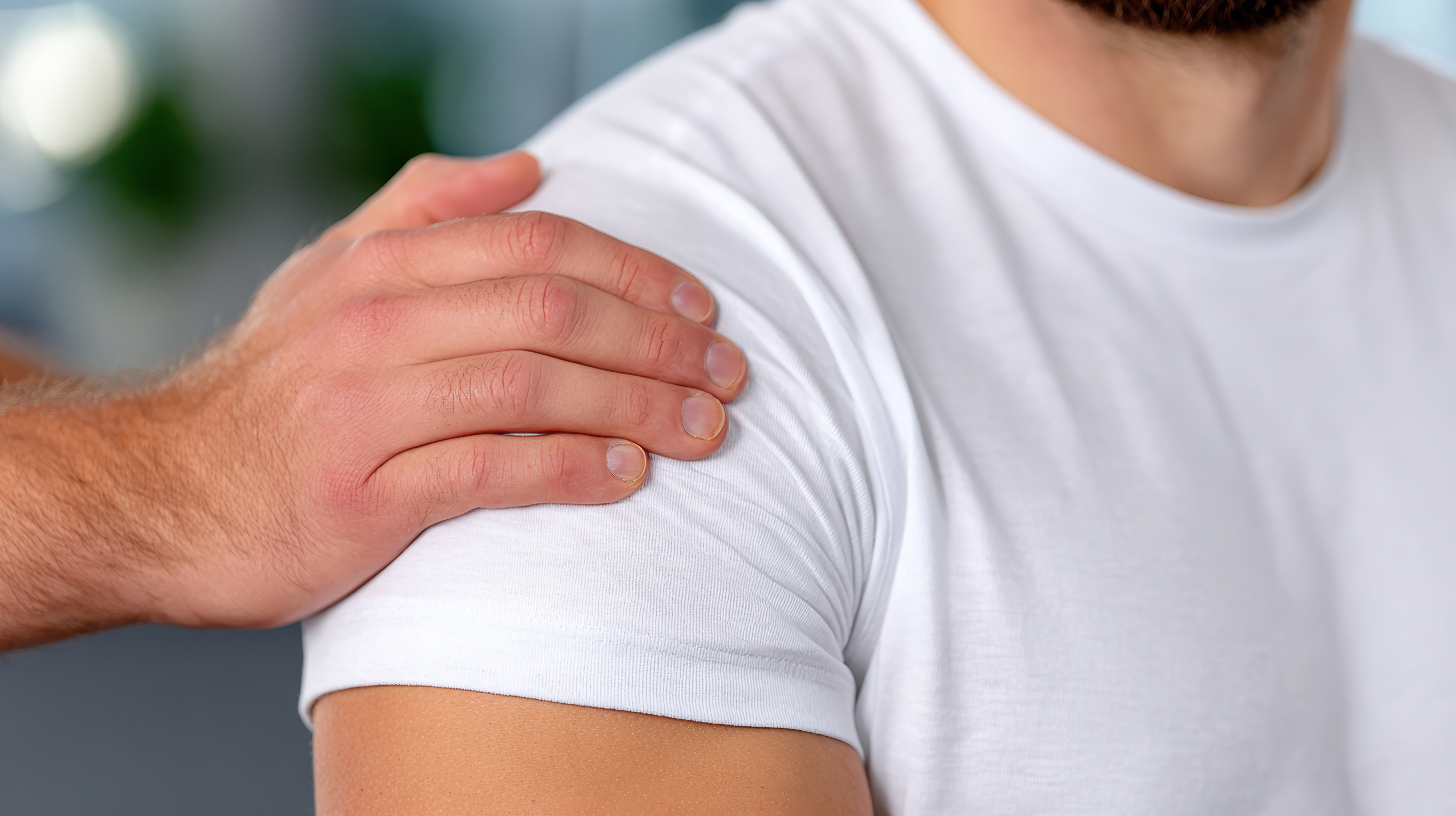 Doctor examining shoulder joint mobility during physical assessment for medical clinic background and physiotherapy poster.
