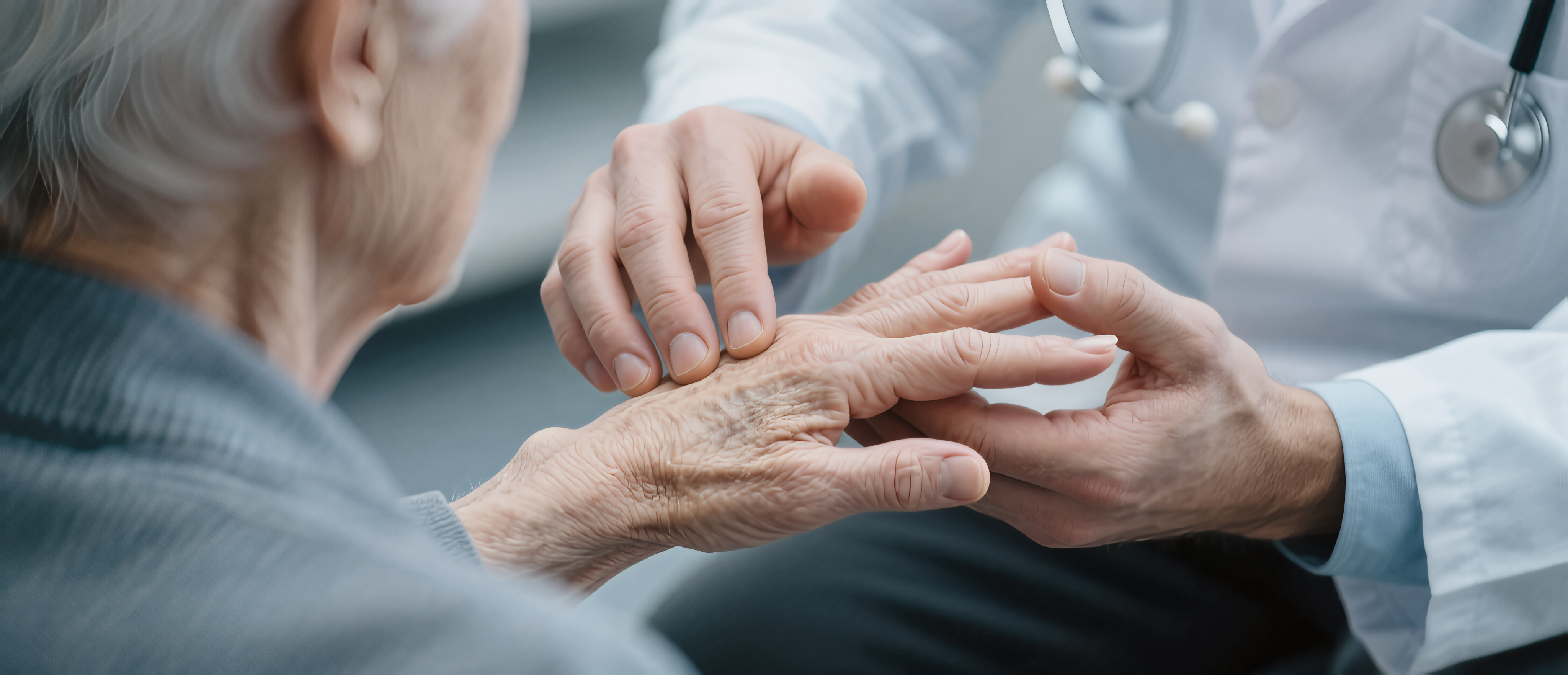 Professional doctor examining senior patient hands for rheumatoid arthritis and joint pain symptoms during a clinical medical checkup in a bright hospital office.